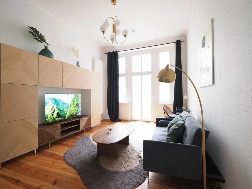 Sofa TV unit coffee table rug living room at Apartment in Simon-Dach-Straße 40, 10245 Berlin, Germany in Berlin Student Accommodation