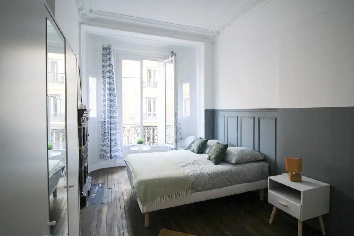 Bed pillows patterned curtains and fireplace bedroom at Room in 4 Rue Jean-François Lépine, 75018 Paris, France in Paris Student Accommodation