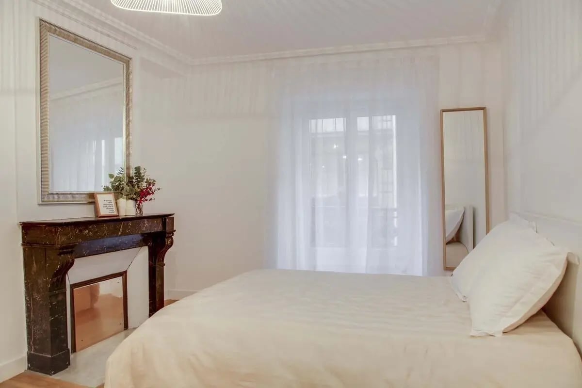 Mirror fireplace bed sheer curtains bedroom at Room in 24 rue Richer Paris 75009 FR in Paris Student Accommodation