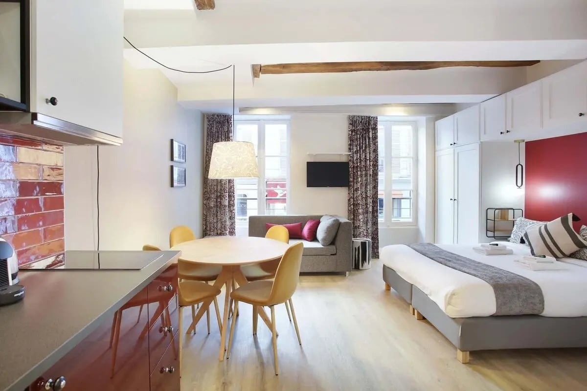 Bed sofa dining table kitchen area studio apartment at Apartment in Rue Cadet, 75009 Paris, France in Paris Student Accommodation