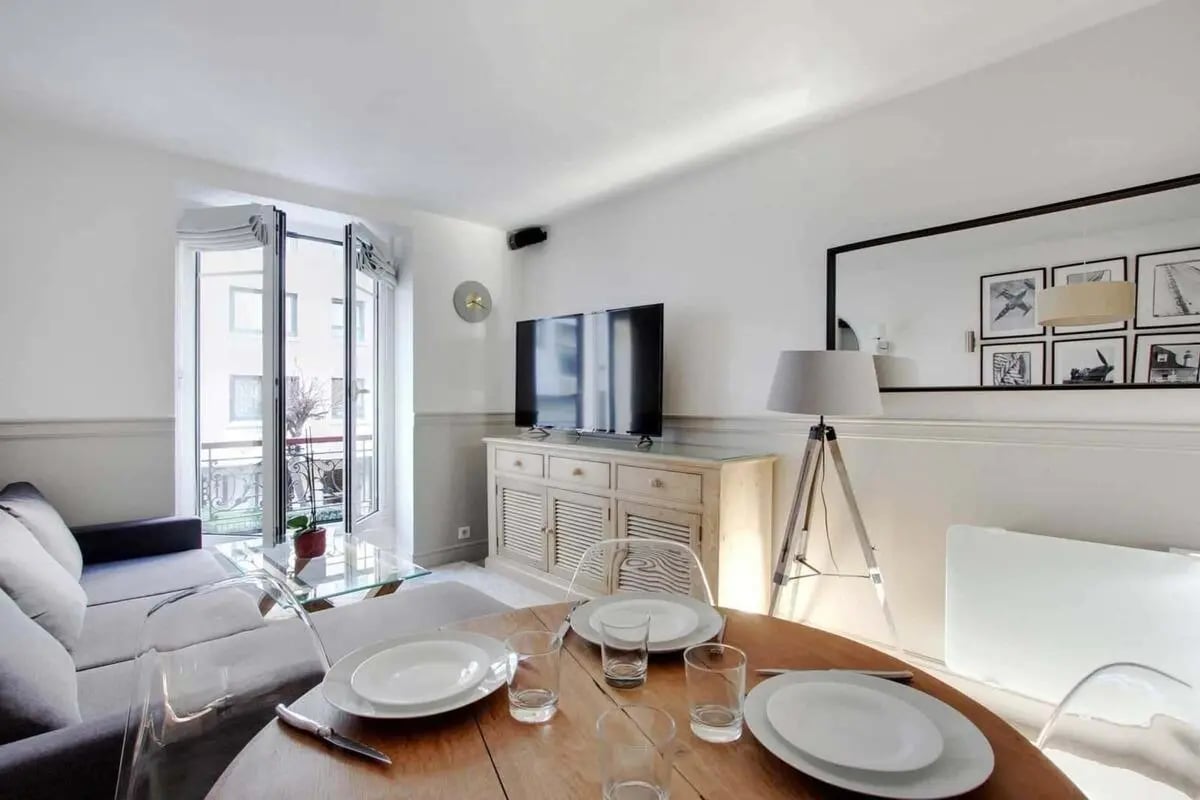 Sofa television sideboard dining table living room at Apartment in 128 Rue du Théâtre, 75015 Paris, France in Paris Student Accommodation