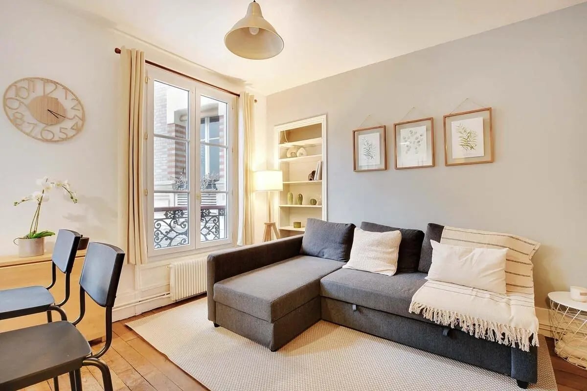 Gray sectional sofa with pillows and throw living room at Apartment in 194 Rue de la Convention, 75015 Paris, France in Paris Student Accommodation
