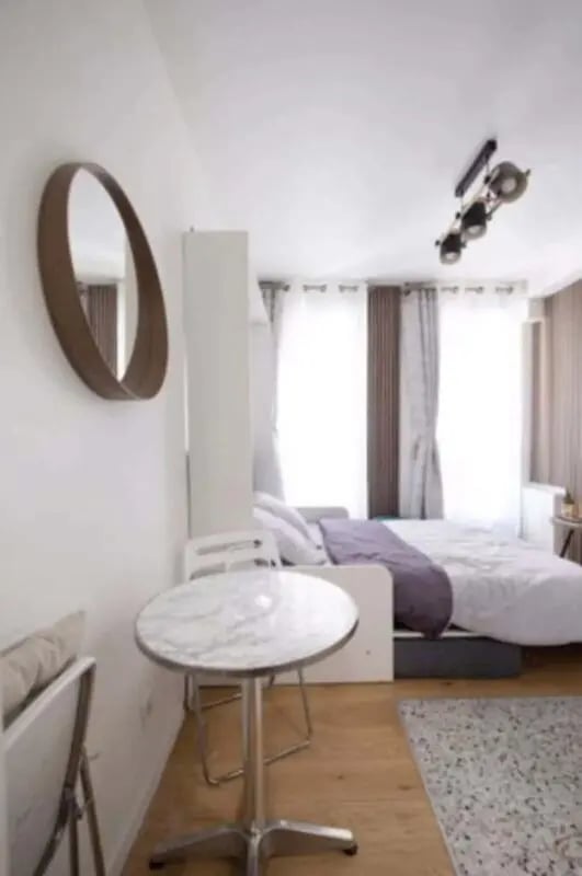 Round table mirror bed with purple blanket bedroom at Studio in 7 Rue Burq, 75018 Paris, France in Paris Student Accommodation