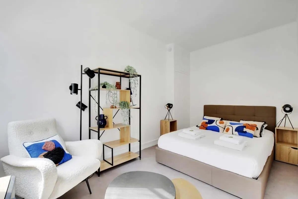Bed chair shelving with plants modern bedroom at Studio in 38 Rue Grégoire de Tours, 75006 Paris, France in Paris Student Accommodation