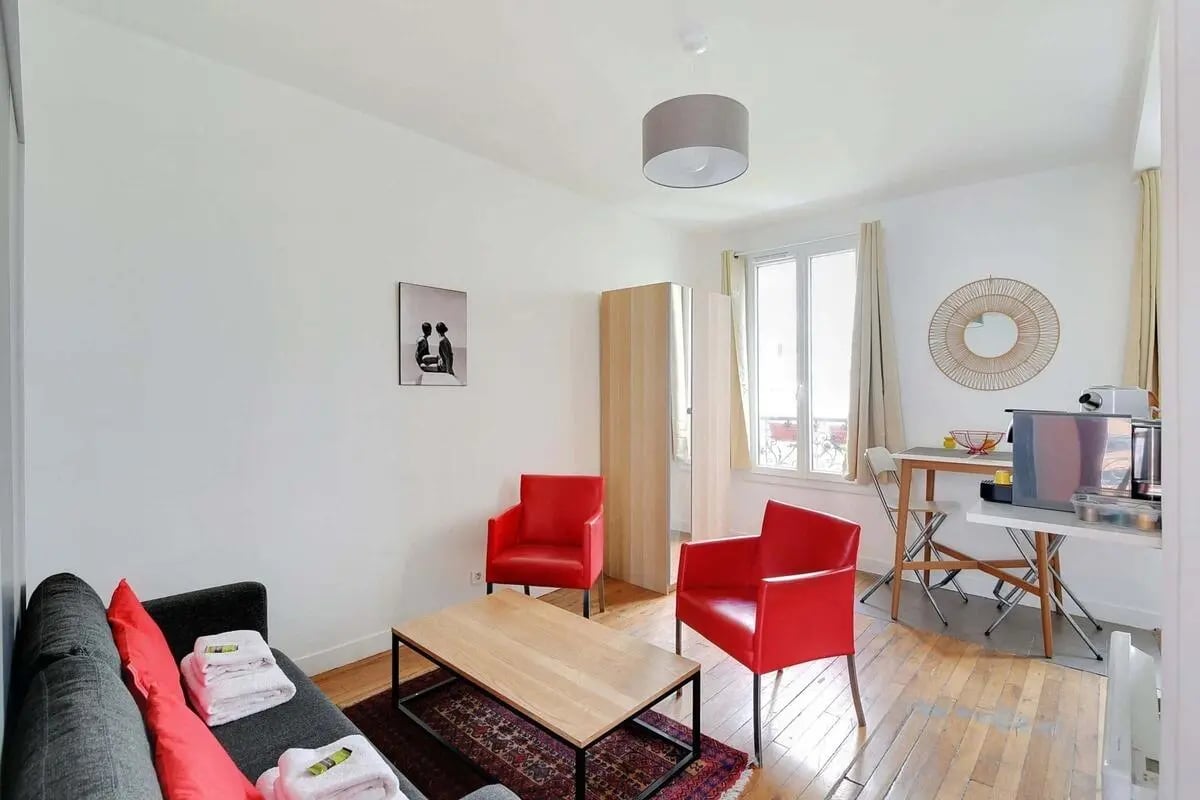 Sofa, chairs, table, kitchenette, artwork living room at Studio in 29 Rue de Meaux, 75019 Paris, France in Paris Student Accommodation