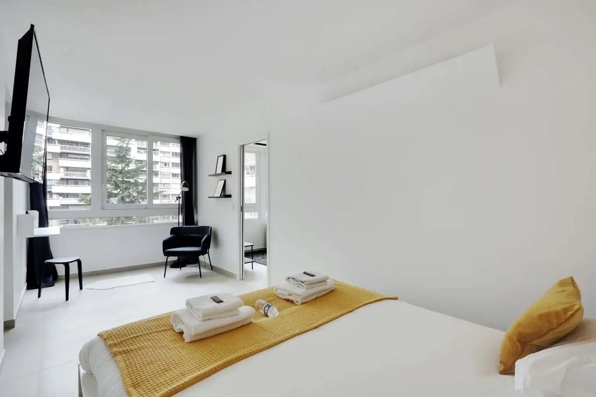 Bed with yellow blanket and towels bedroom at Apartment in 127 Av. de Flandre, 75019 Paris, France in Paris Student Accommodation