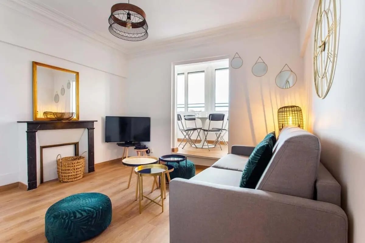 Sofa tv fireplace mirror balcony living room at Apartment in 36 Bd du Temple, 75011 Paris, France in Paris Student Accommodation