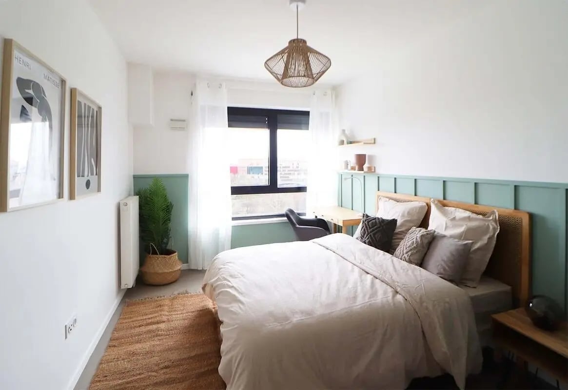 Bed desk plant artwork and rug bedroom at Room in 181 Bd Macdonald, 75019 Paris, France in Paris Student Accommodation