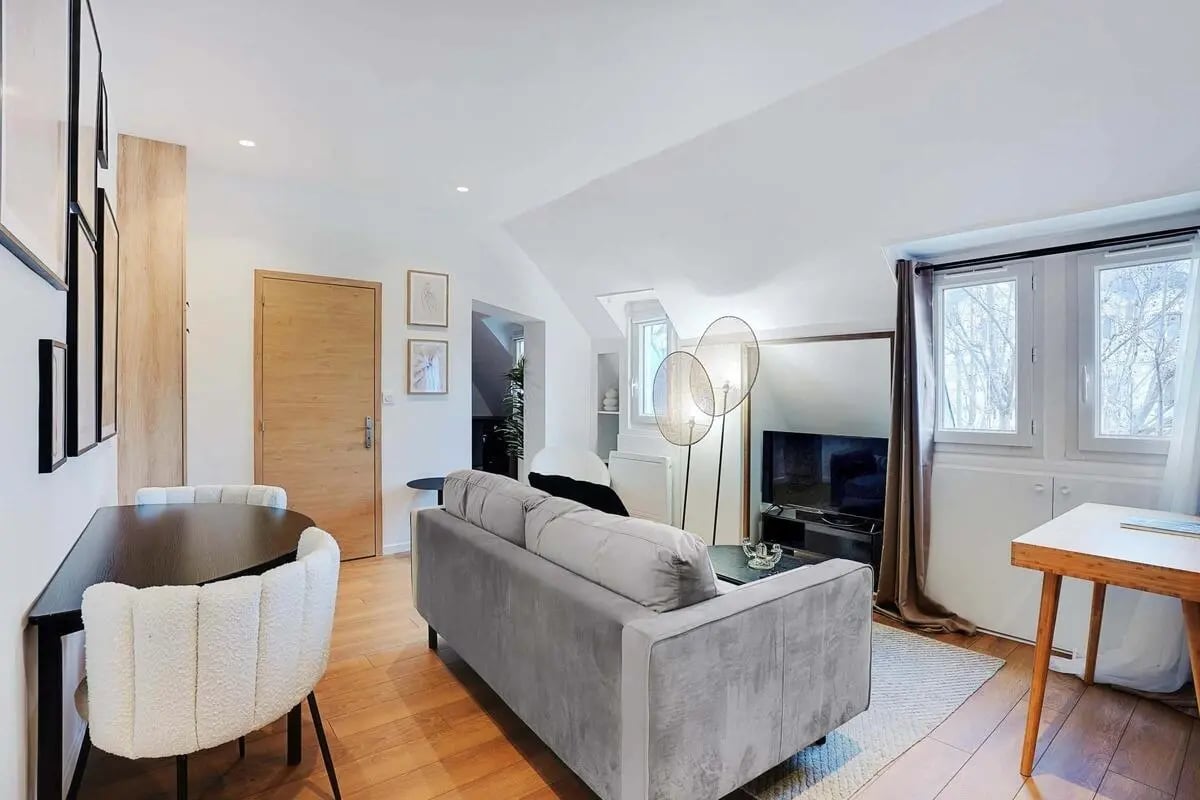 Sofa tv and dining table living room at Apartment in 1 Rue de Courty, 75007 Paris, France in Paris Student Accommodation