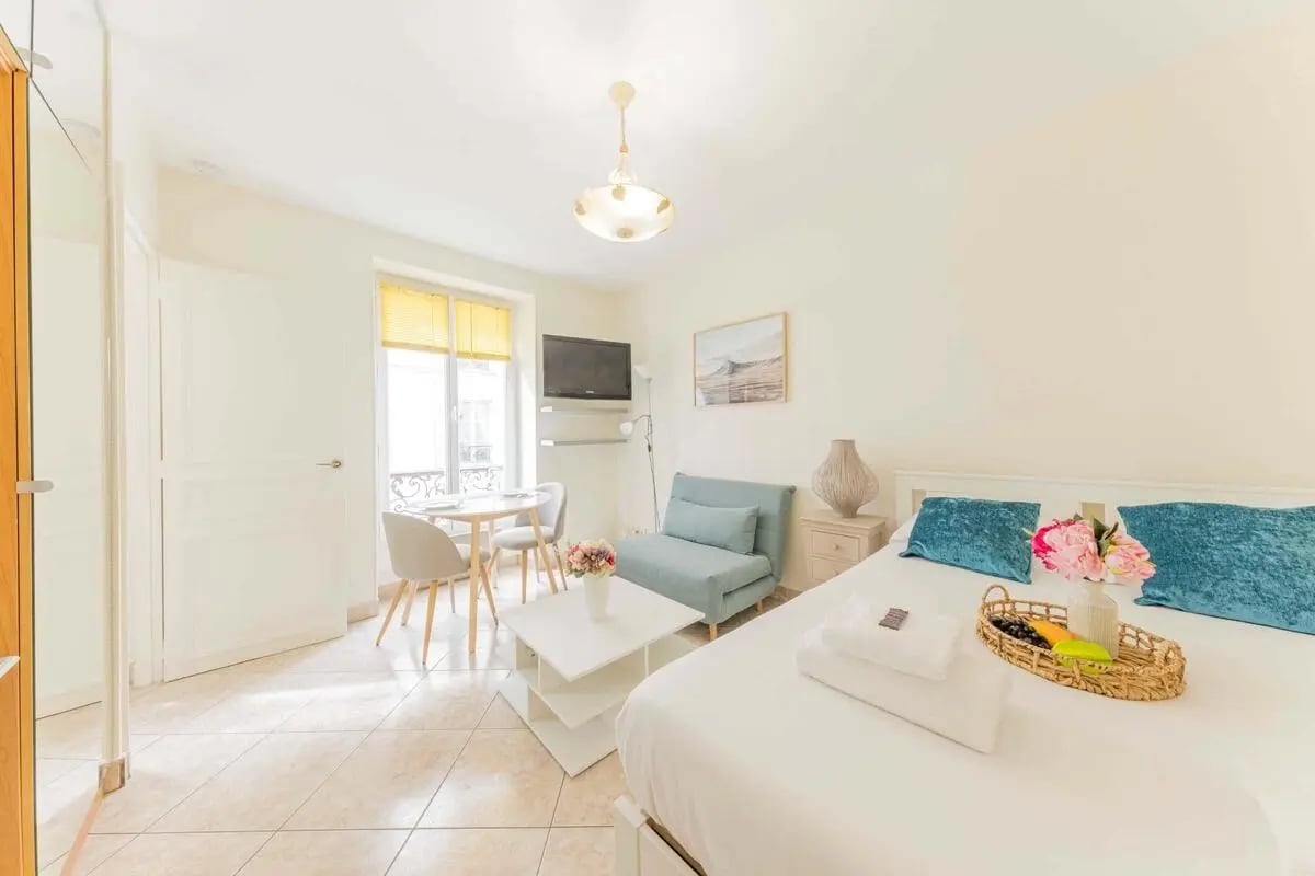 Bed sofa table window and television studio apartment at Studio in 23 Rue de l'Exposition, 75007 Paris, France in Paris Student Accommodation