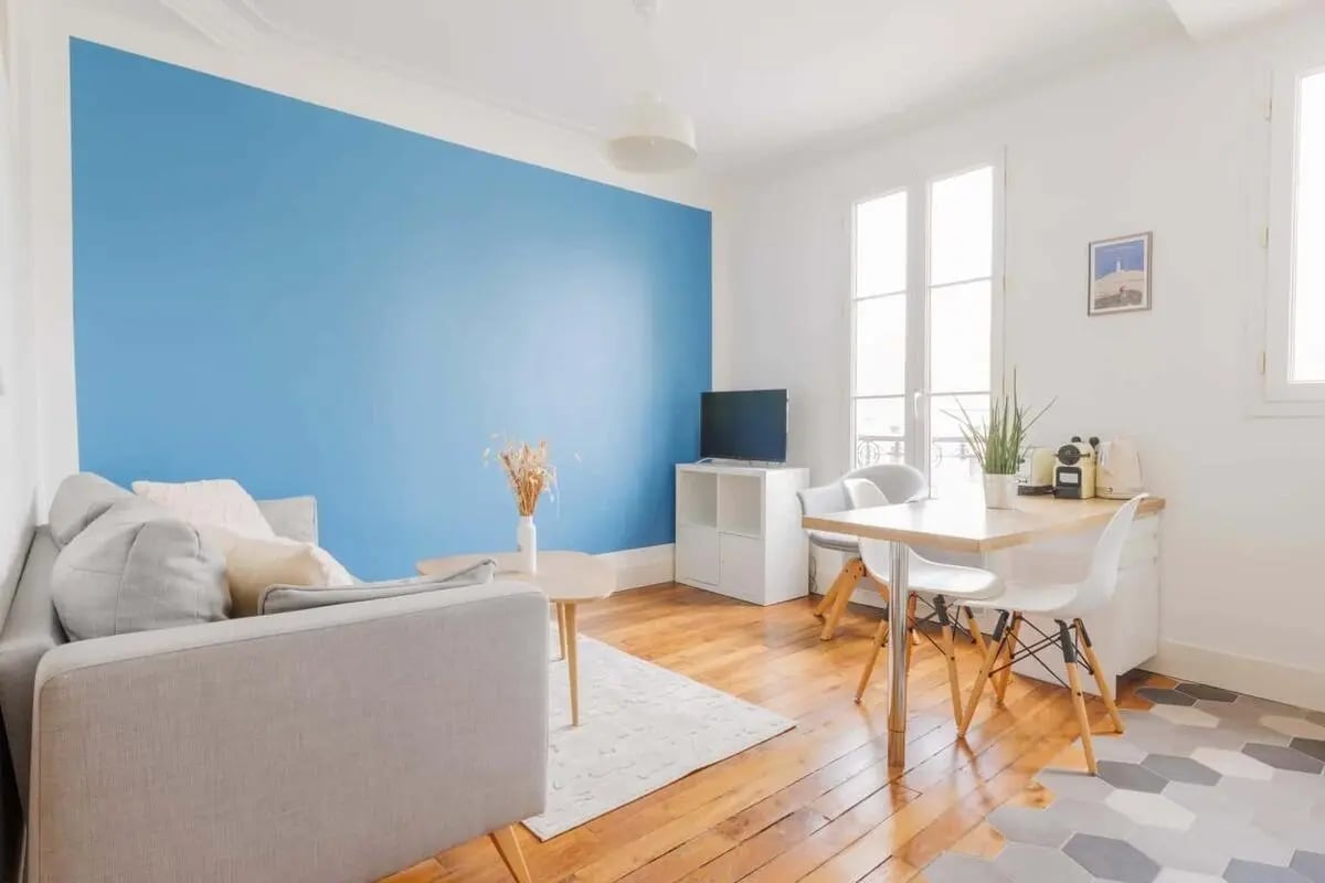 Sofa television dining table and chairs living room at Apartment in 169 Rue Legendre, 75017 Paris, France in Paris Student Accommodation