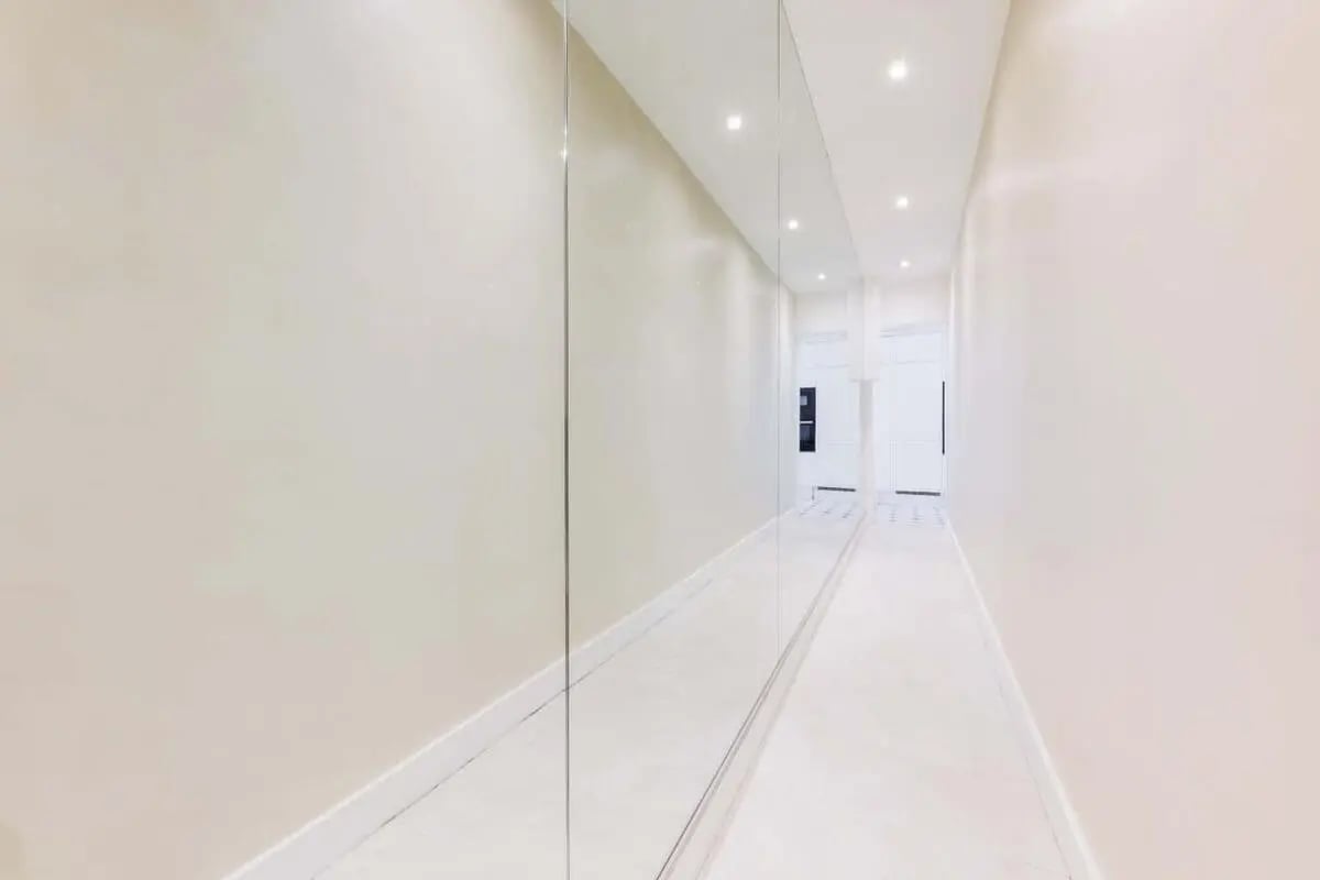 Mirrored hallway with tiled floor and ceiling lights hallway at Apartment in 10 Rue Sedillot, 75007 Paris, France in Paris Student Accommodation