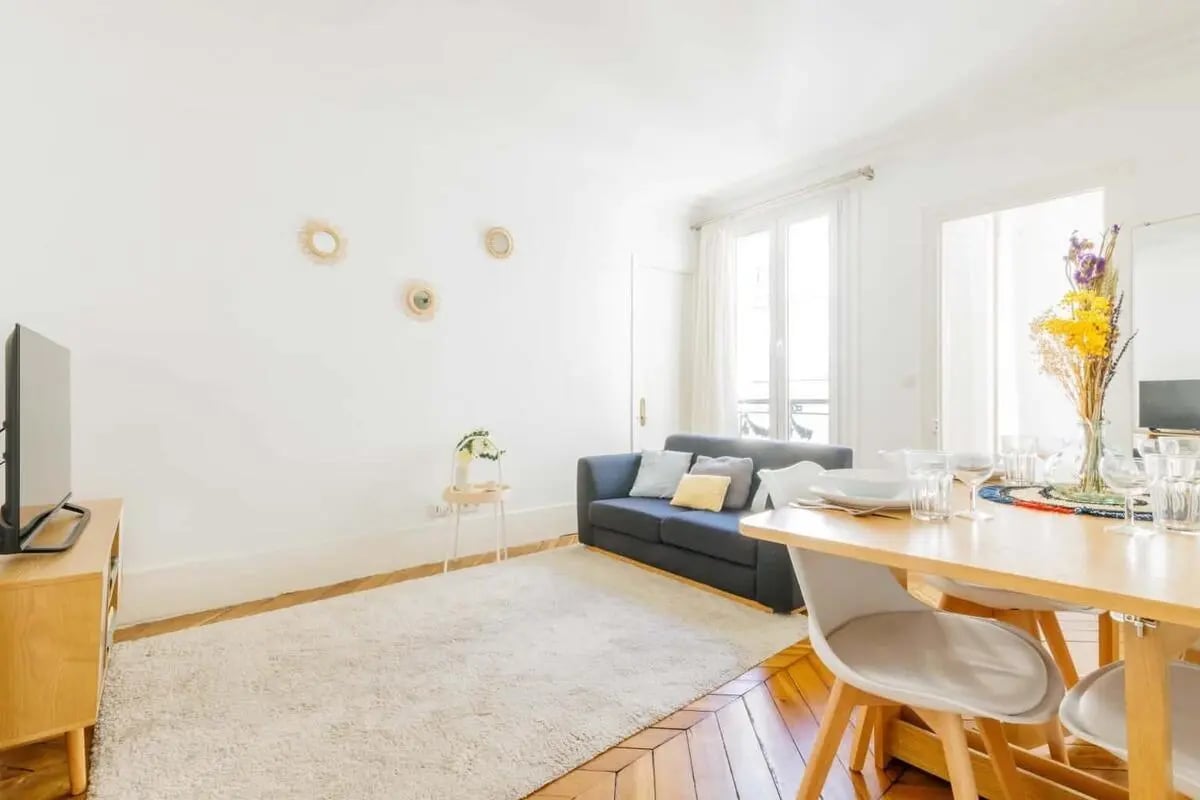Sofa rug dining table with chairs living room at Apartment in 19 Rue Bleue, 75009 Paris, France in Paris Student Accommodation
