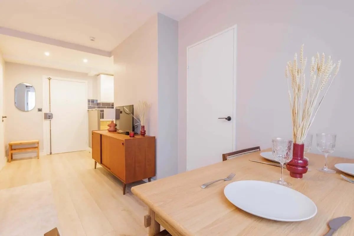 Dining area with table chairs TV cabinet hallway living area at Apartment in 54 Av. de Versailles, 75016 Paris, France in Paris Student Accommodation
