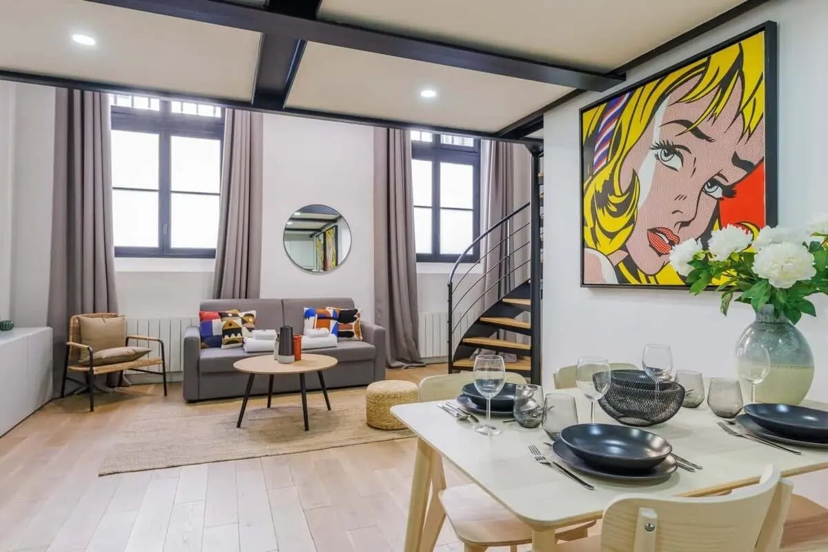 Sofa with pillows round table chair with artworks living room at Apartment in 13 Rue de Bellechasse, 75007 Paris, France in Paris Student Accommodation