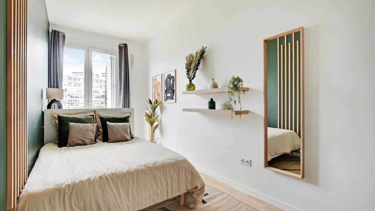 Bed with pillows lamp art shelves and mirror bedroom at Room in 42 Rue Cesária Évora, 75019 Paris, Francia in Paris Student Accommodation