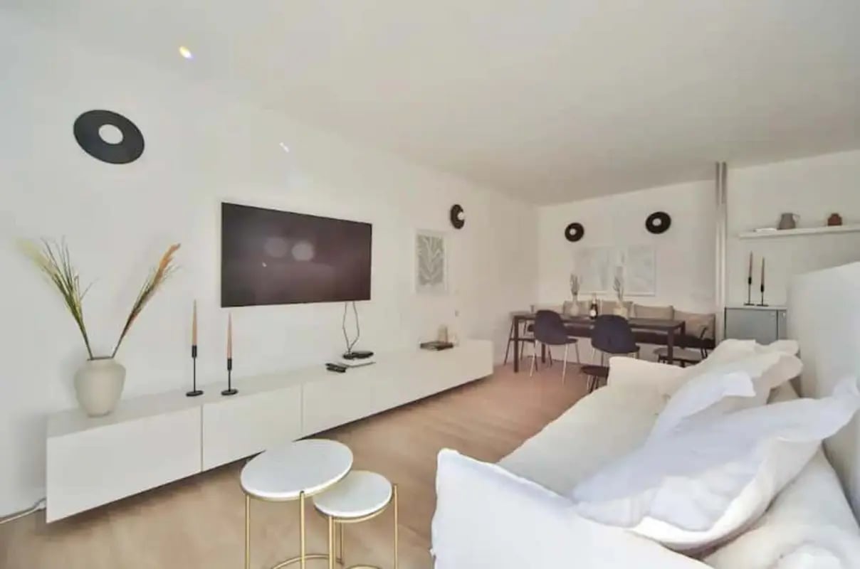 Sofa dining table television living room at Apartment in Pass. Delessert, 75010 Paris, France in Paris Student Accommodation