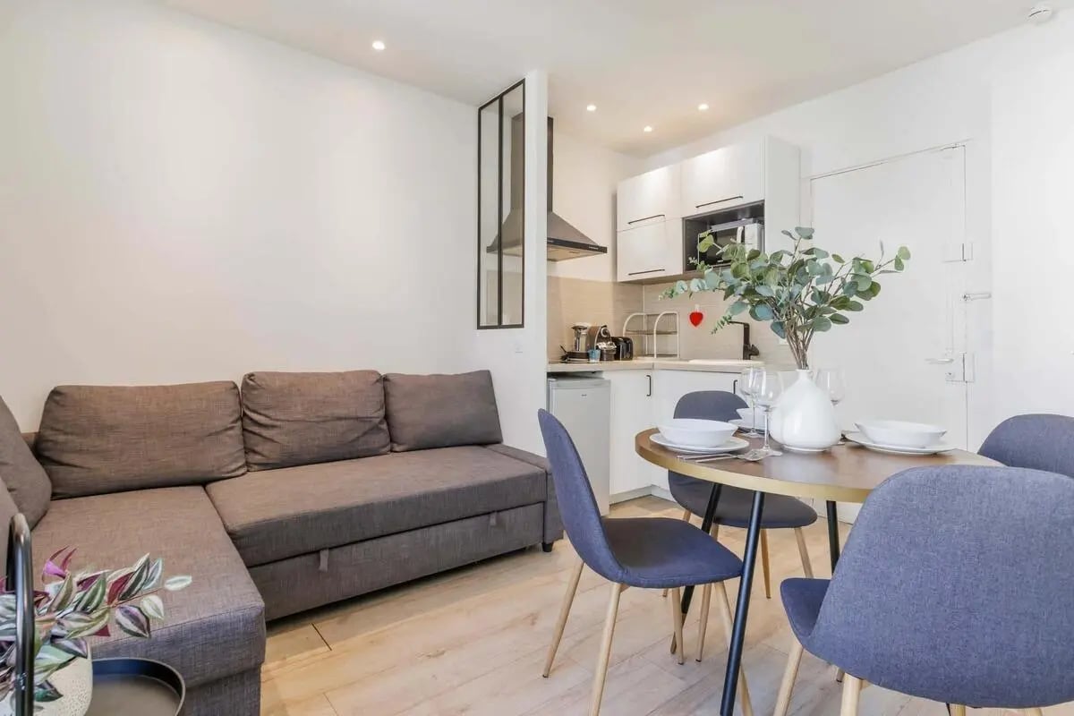 Grey sofa dining table chairs kitchen living room at Apartment in 18 Rue Mayet, 75006 Paris, France in Paris Student Accommodation