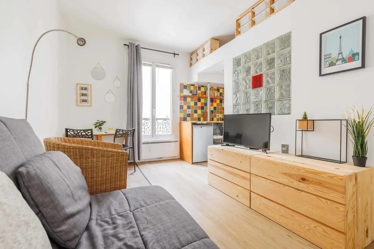 Sofa dining table fridge colorful kitchen living area living room at Studio in 14 Rue Clouet, 75015 Paris, France in Paris Student Accommodation