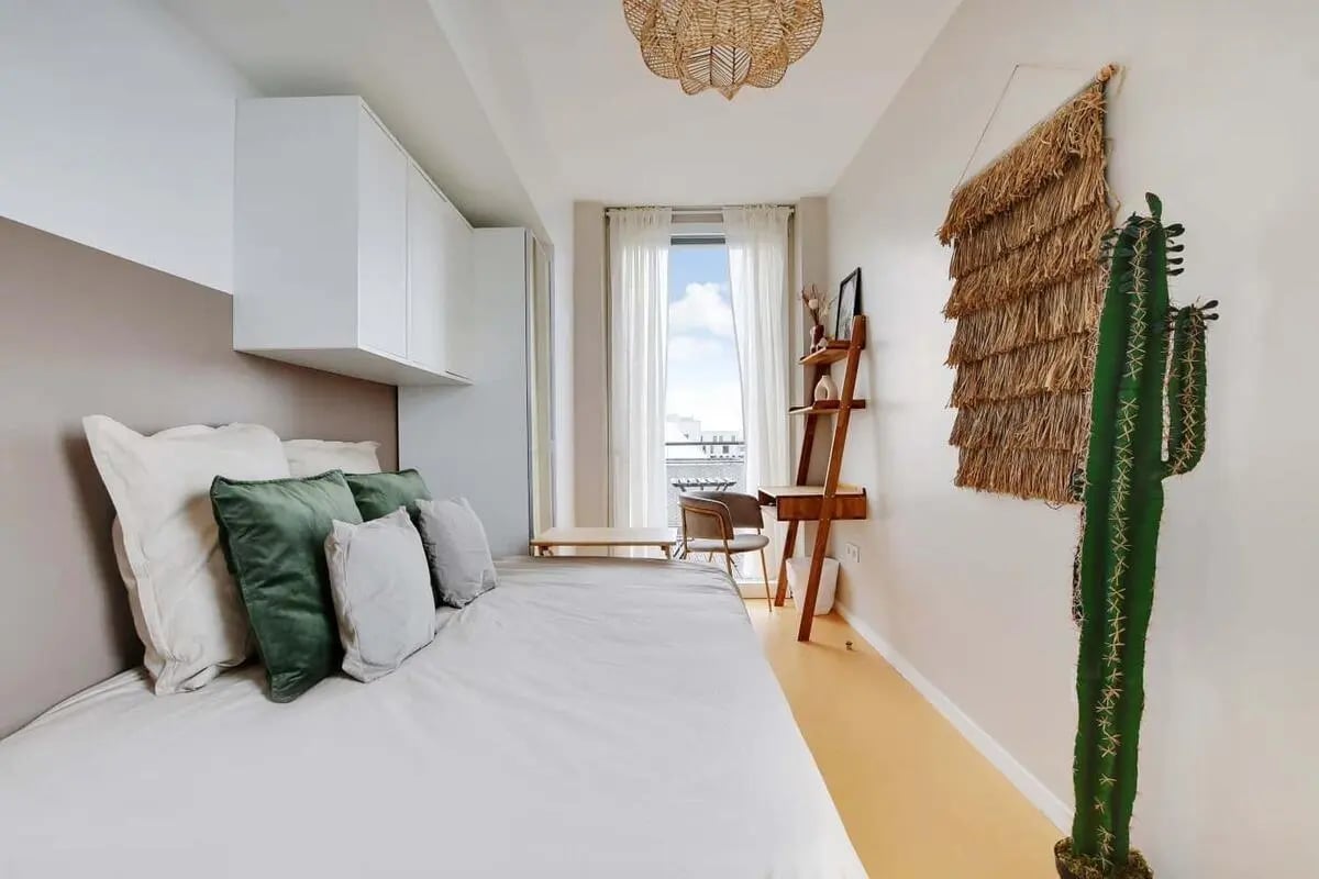 Bed with pillows desk and cactus Bedroom at Room in 58 Rue Cesária Évora, 75019 Paris, France in Paris Student Accommodation