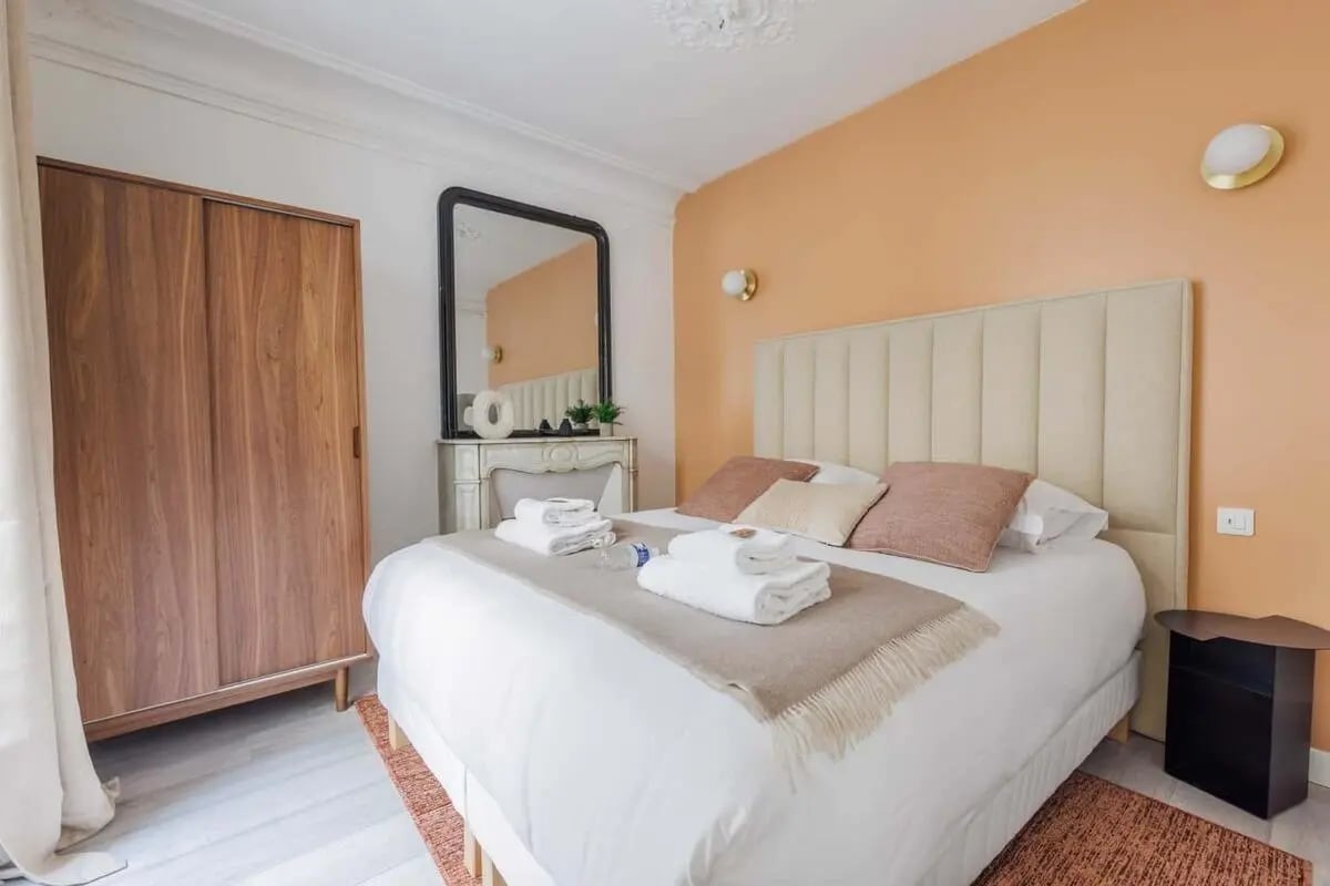 Bed with fireplace mirror and wardrobe bedroom at Apartment in 15 Rue Danielle Casanova, 75001 Paris, France in Paris Student Accommodation