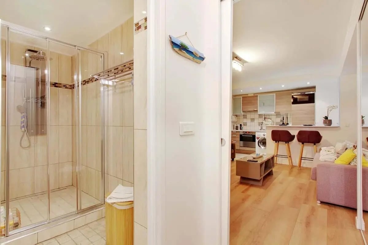 Glass shower stall kitchen and living area living room at Studio in 21 Rue Curial, 75019 Paris, France in Paris Student Accommodation