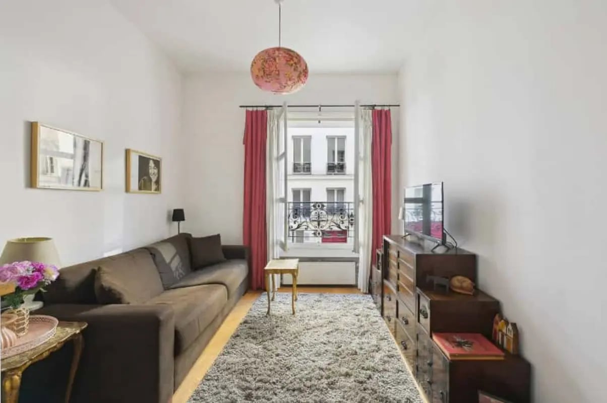 Sofa rug dresser with TV living room at Studio in 39 Rue Gabrielle, 75018 Paris, France in Paris Student Accommodation