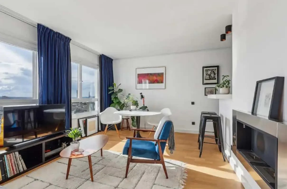 Modern living room with blue curtains and furniture Living room at Studio in 16 Rue Vandrezanne, 75013 Paris, France in Paris Student Accommodation