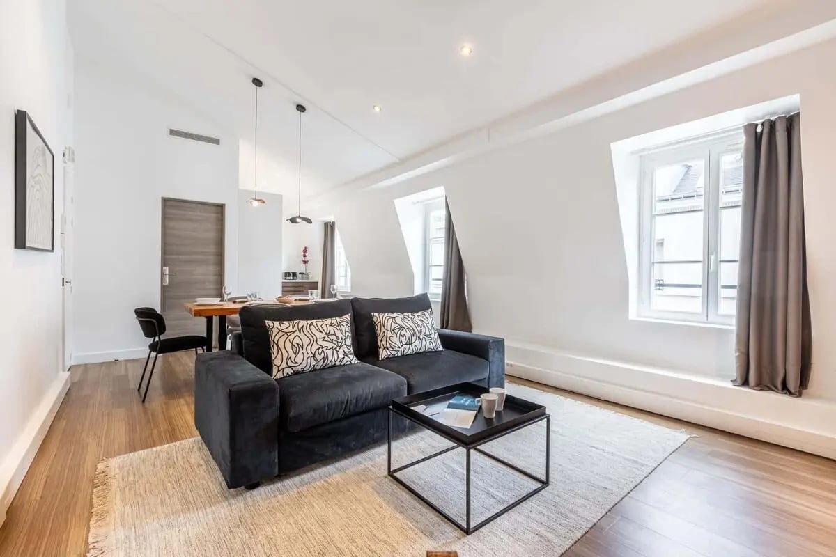 Sofa with patterned pillows and coffee table Living room at Apartment in 7 Rue Monsigny, 75002 Paris, France in Paris Student Accommodation