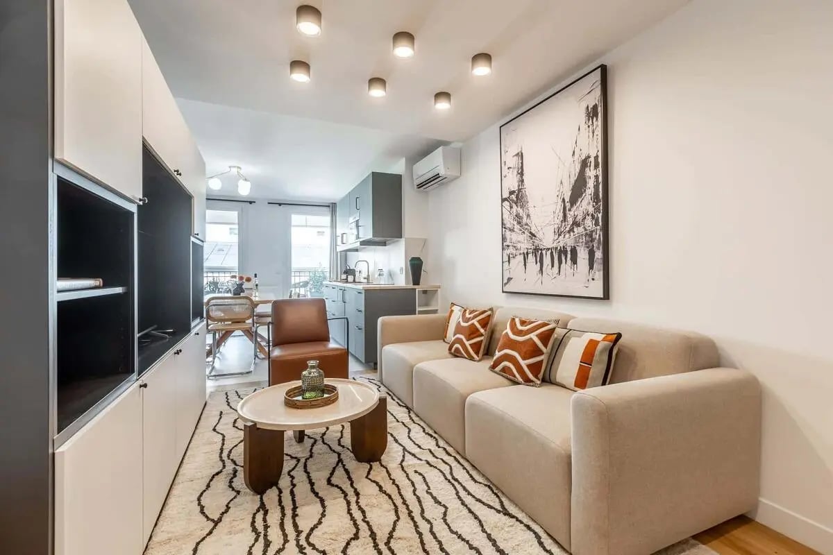 Sofa coffee table art kitchen dining living room at Apartment in 1 Rue Cauchois 2, 75018 Paris, France in Paris Student Accommodation