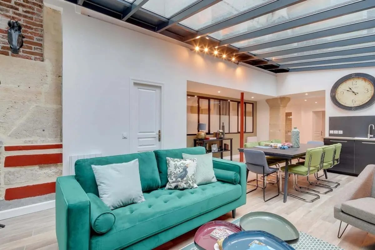 Green sofa dining table and kitchen living area at Apartment in 13 Rue du Sentier 2, 75002 Paris, France in Paris Student Accommodation