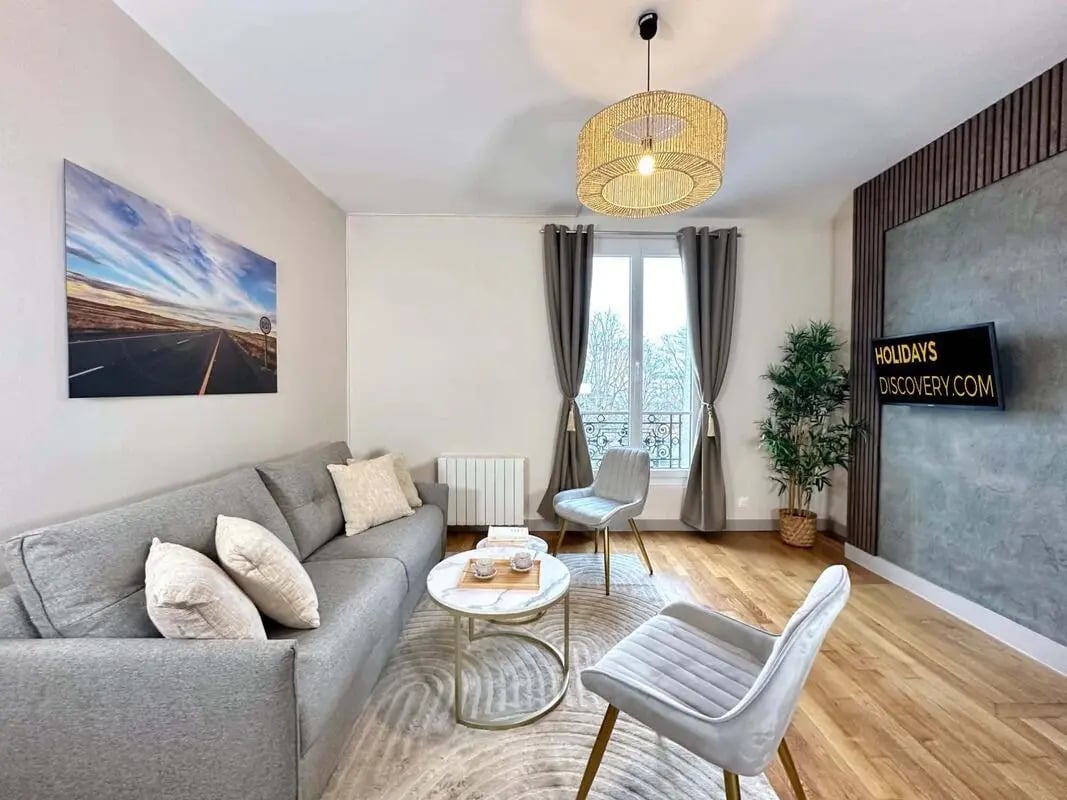 Sofa coffee table chairs artwork on wall living room at Apartment in 2 Rue Jean Marie Jego, 75013 Paris, France in Paris Student Accommodation