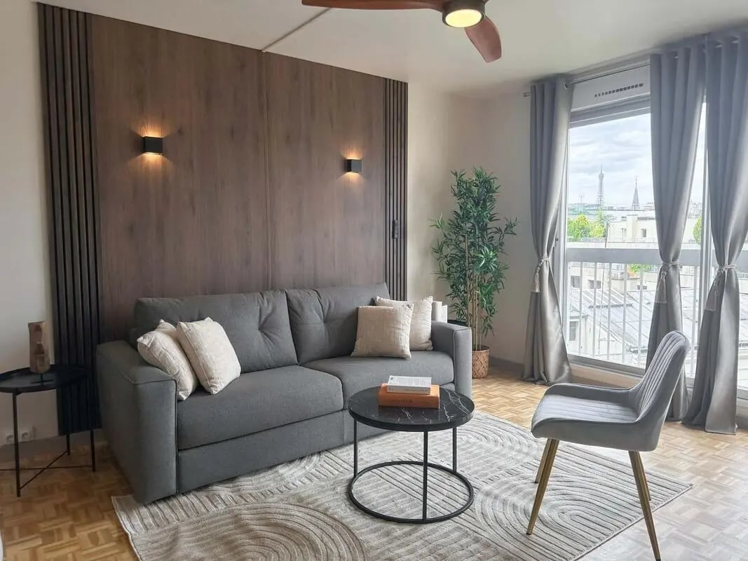 Grey sofa, coffee table, chair, plant, living room at Studio in 203 Rue de la Convention, 75015 Paris, France in Paris Student Accommodation