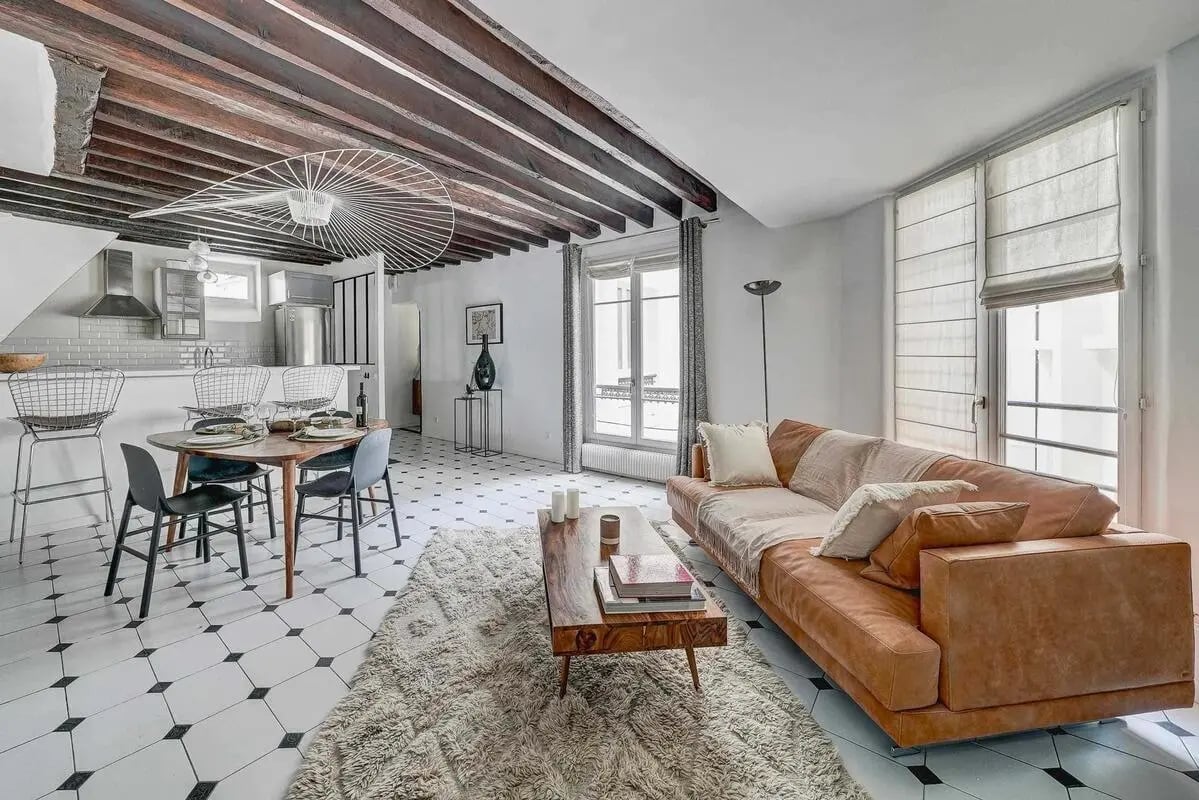 Sofa coffee table dining set patterned floor living room at Apartment in 136 Rue Amelot, 75011 Paris, France in Paris Student Accommodation