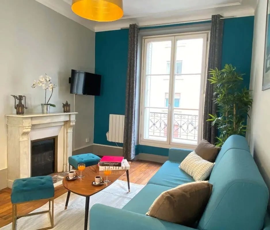Turquoise sofa fireplace ornate window living room at Apartment in 198 Rue de la Croix Nivert, 75015 Paris, France in Paris Student Accommodation