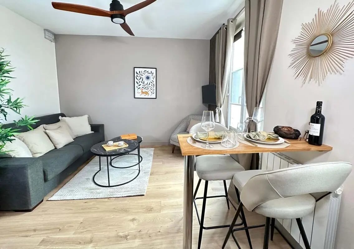 Sofa coffee table rug chairs and dining table living room at Studio in 26 Pass. de la Vierge, 75007 Paris, France in Paris Student Accommodation