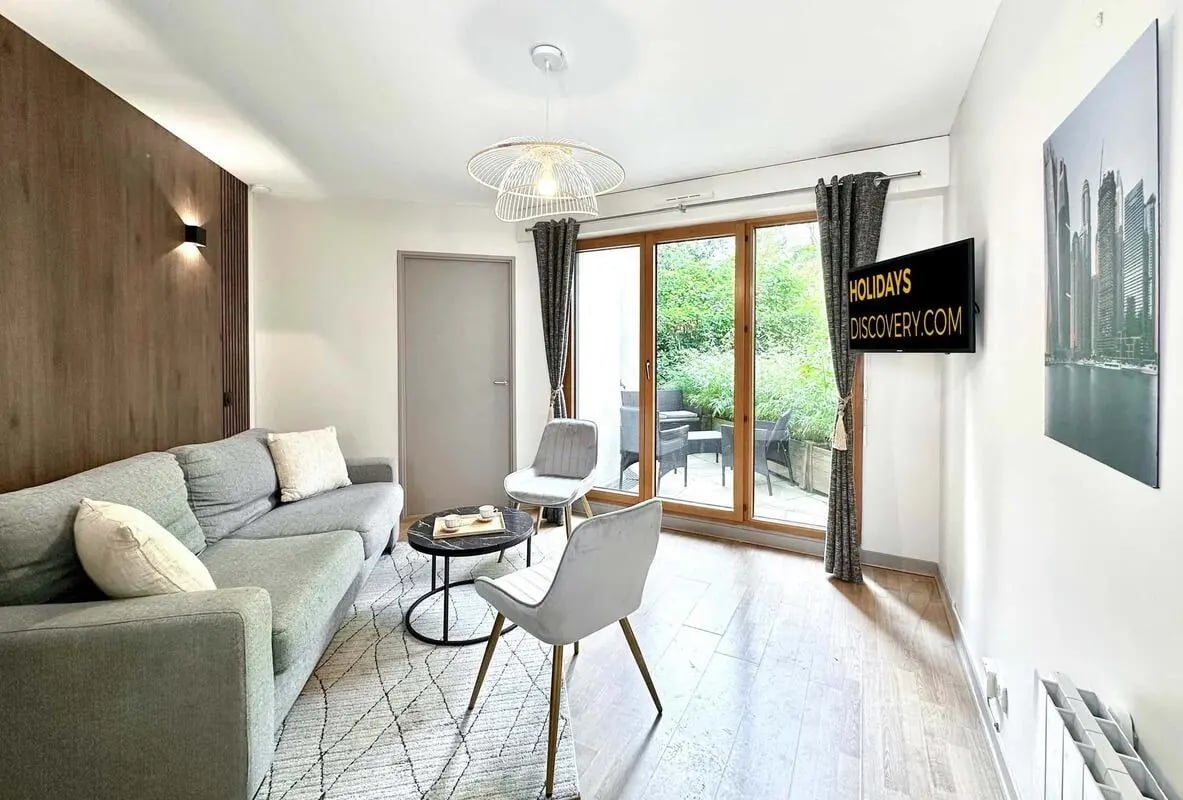 Sofa coffee table chairs and large window Living room at Studio in 2 Rue Brancion, 75015 Paris, France in Paris Student Accommodation