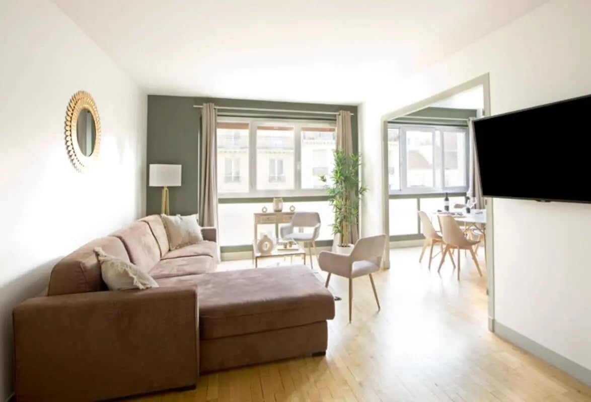 Brown sectional sofa lamp dining table and chairs living room at Apartment in 68 Rue Lecourbe, 75015 Paris, France in Paris Student Accommodation