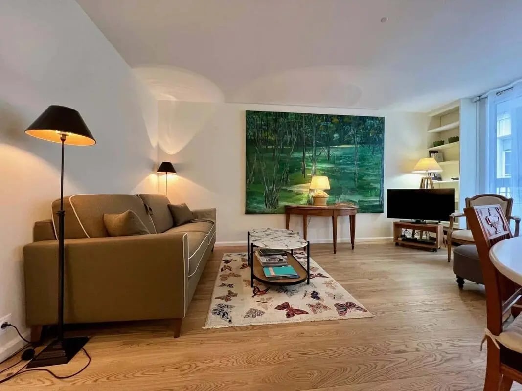 Sofa coffee table painting and TV living room at Apartment in 8 Rue Saint-Jean-Baptiste de la Salle, 75006 Paris, France in Paris Student Accommodation
