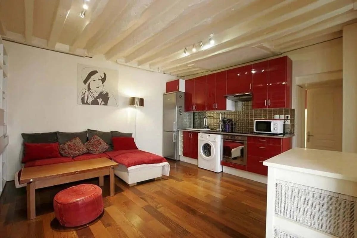 Red kitchen sofa bed and artwork living area at Apartment in 22 Rue de Picardie, 75003 Paris, France in Paris Student Accommodation