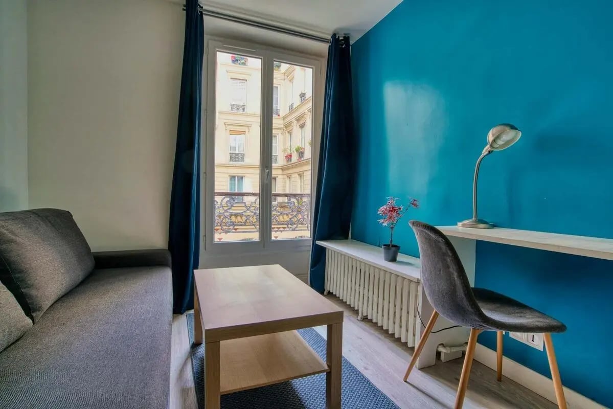 Sofa coffee table chair desk lamp living room at Studio in Rue d'Enghien, 75010 Paris, France in Paris Student Accommodation
