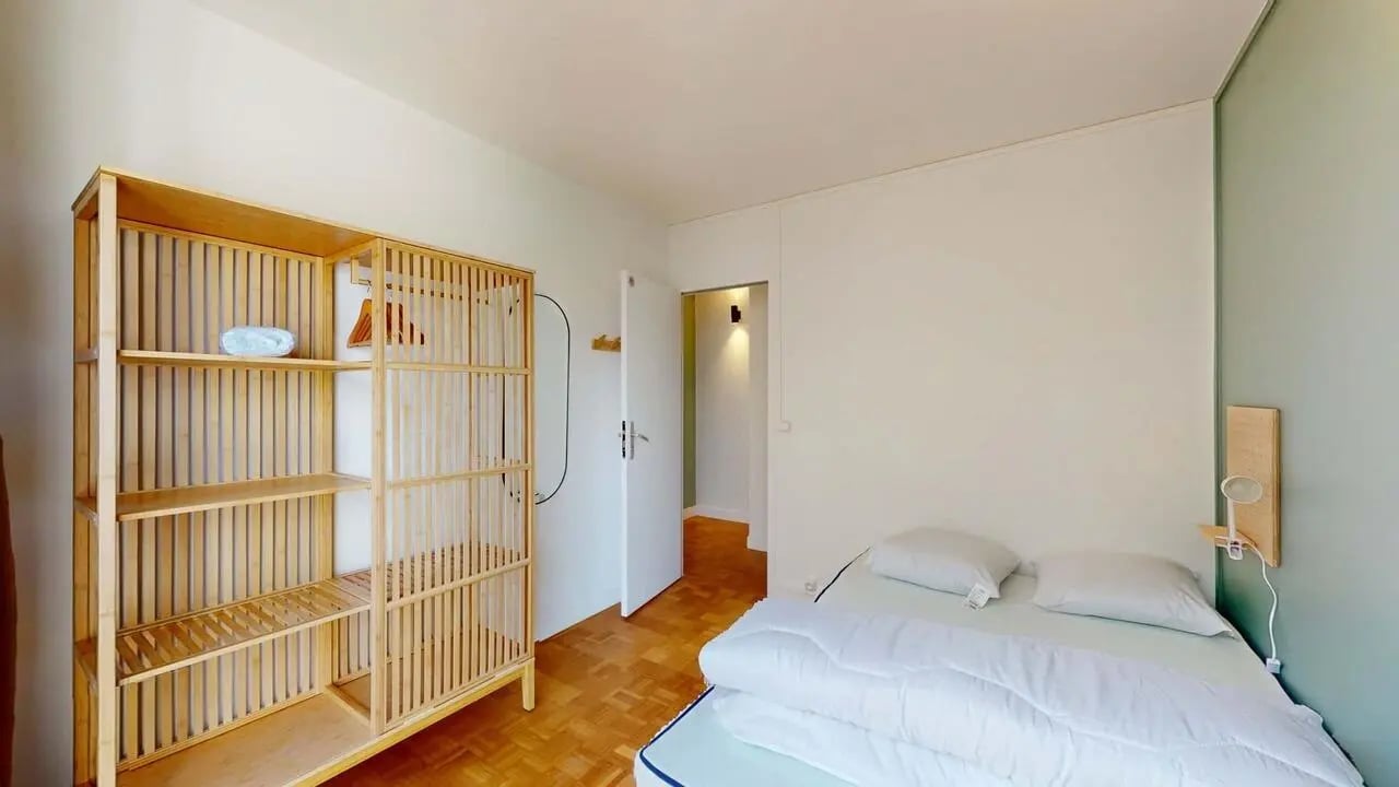 Wooden shelves and a made bed bedroom at Room in 99 Rue Bobillot, 75013 Paris, France in Paris Student Accommodation