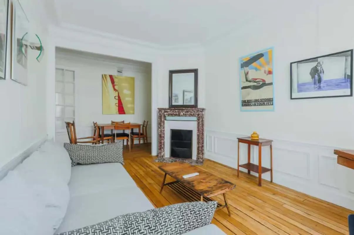 Sofa fireplace dining table living room at Apartment in 21 Rue des Filles du Calvaire, 75003 Paris, France in Paris Student Accommodation