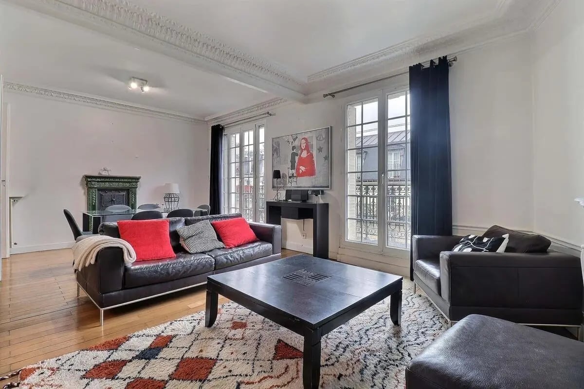 Leather sofa fireplace art ornate molding living room at Apartment in Rue de l'Aqueduc, 75010 Paris, France in Paris Student Accommodation