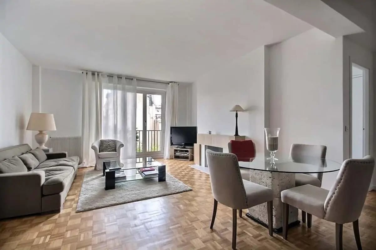 Sofa chairs dining table and TV living room at Apartment in Av. Théophile Gautier, 75016 Paris, France in Paris Student Accommodation