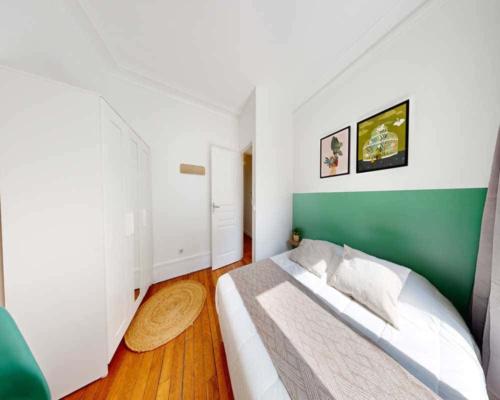 White wardrobe bed with green headboard bedroom at Room in 61 Rue des Cloys, 75018 Paris, France in Paris Student Accommodation