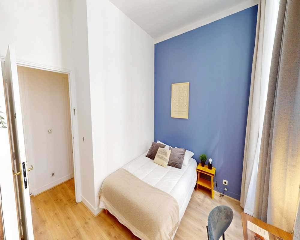 Bed with pillows and side table bedroom at Room in 35 Av. de l'Opéra, 75002 Paris, France in Paris Student Accommodation