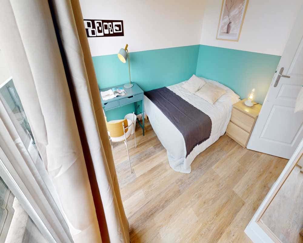 Bed desk chair artwork and bedside table bedroom at Room in 22 Rue de Vouillé, 75015 Paris, France in Paris Student Accommodation