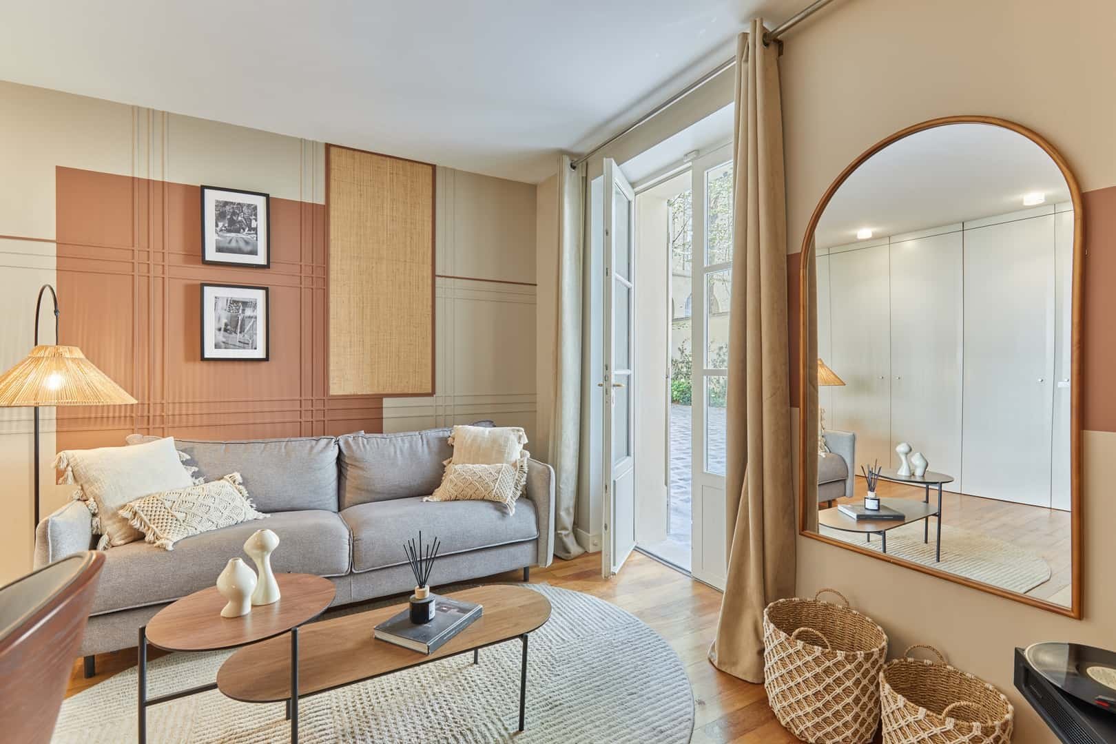 Gray sofa oval tables mirror and baskets living room at Apartment in 86 Rue de Grenelle, 75007 Paris, France in Paris Student Accommodation