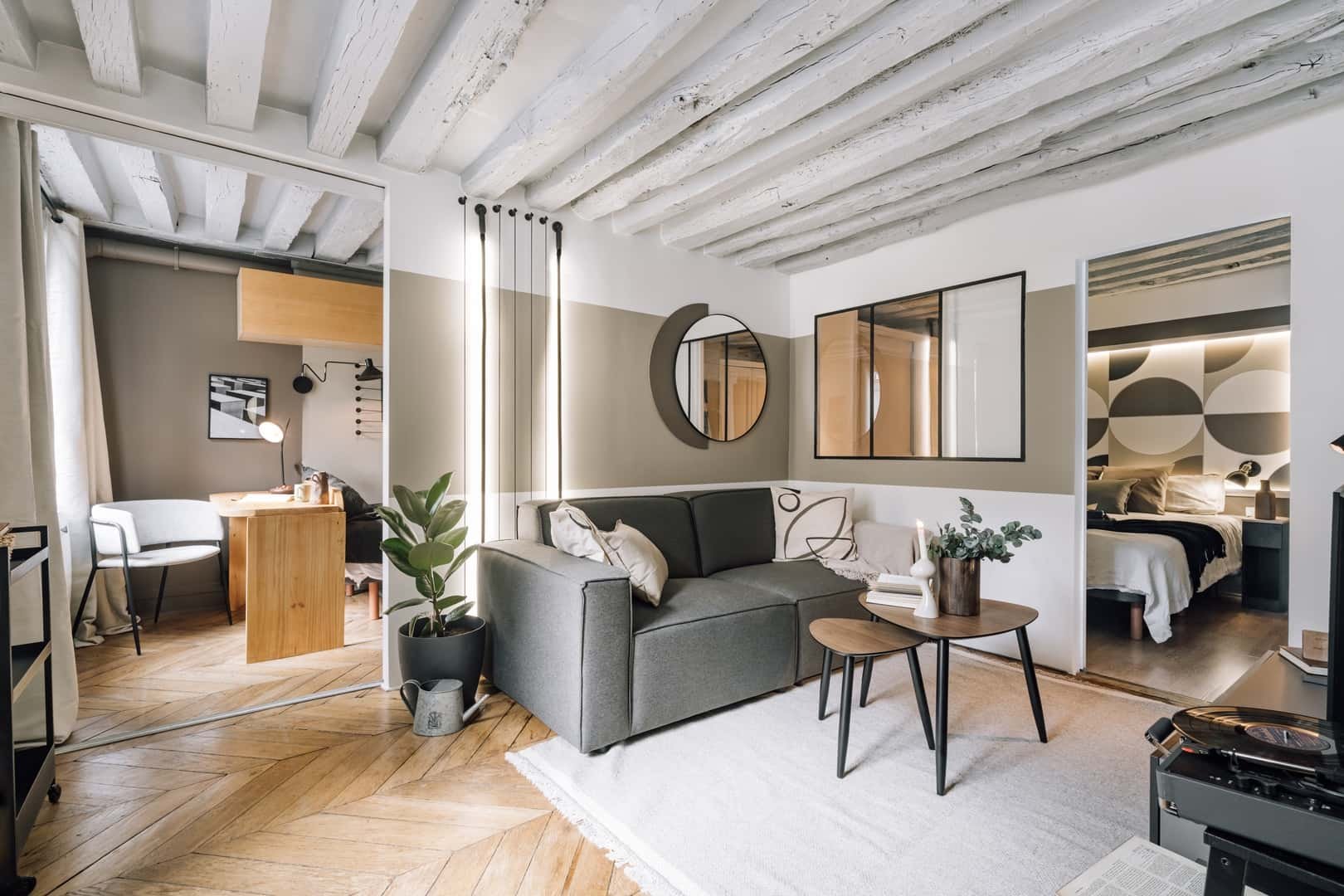 Sofa study area bed and ceiling beams living room at Apartment in 43 Rue Sainte-Anne, 75001 Paris, France in Paris Student Accommodation